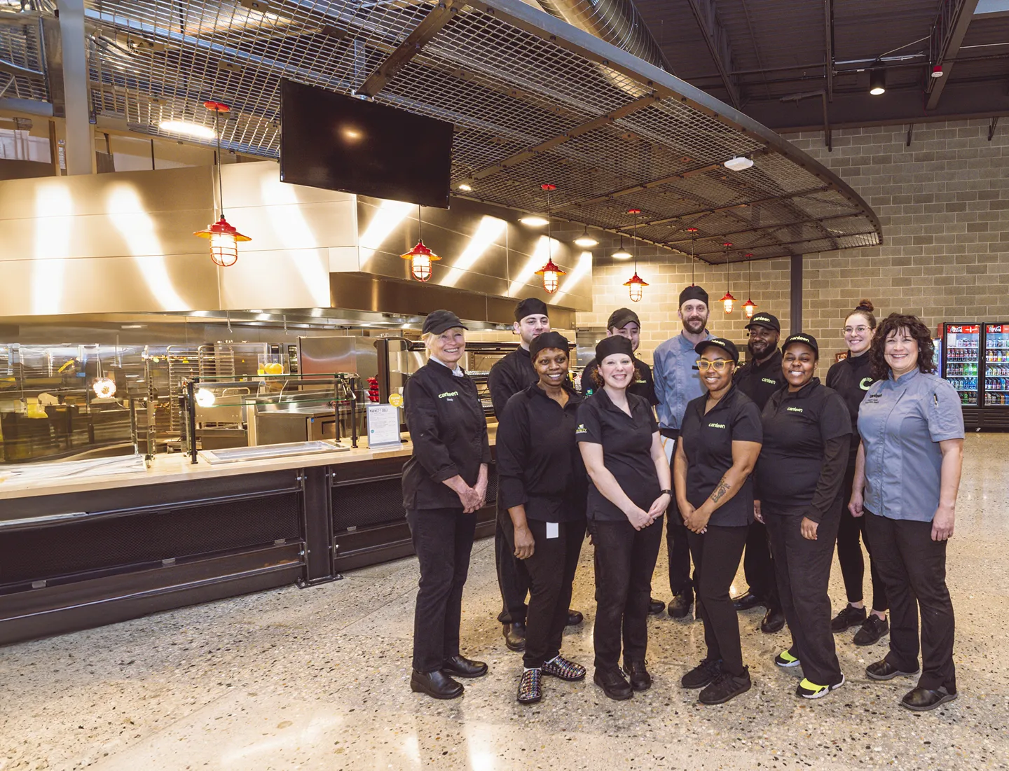 Compass group's employees taking picture inside their restaurant